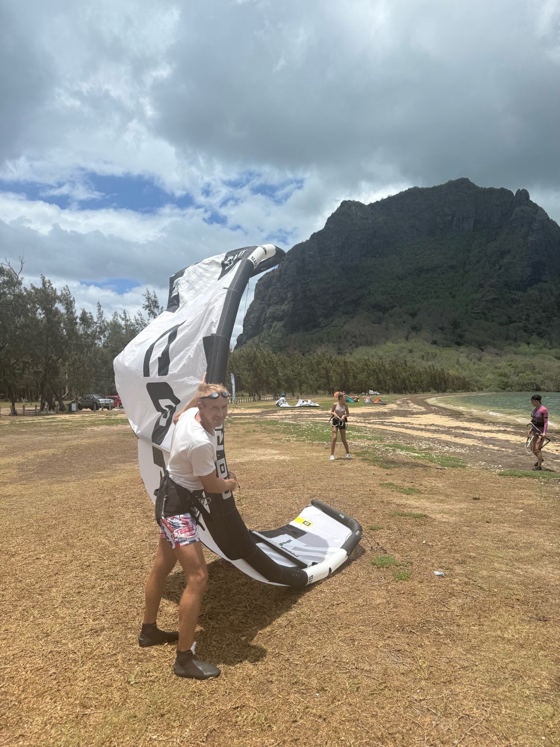 Student launching a kite with instructor support